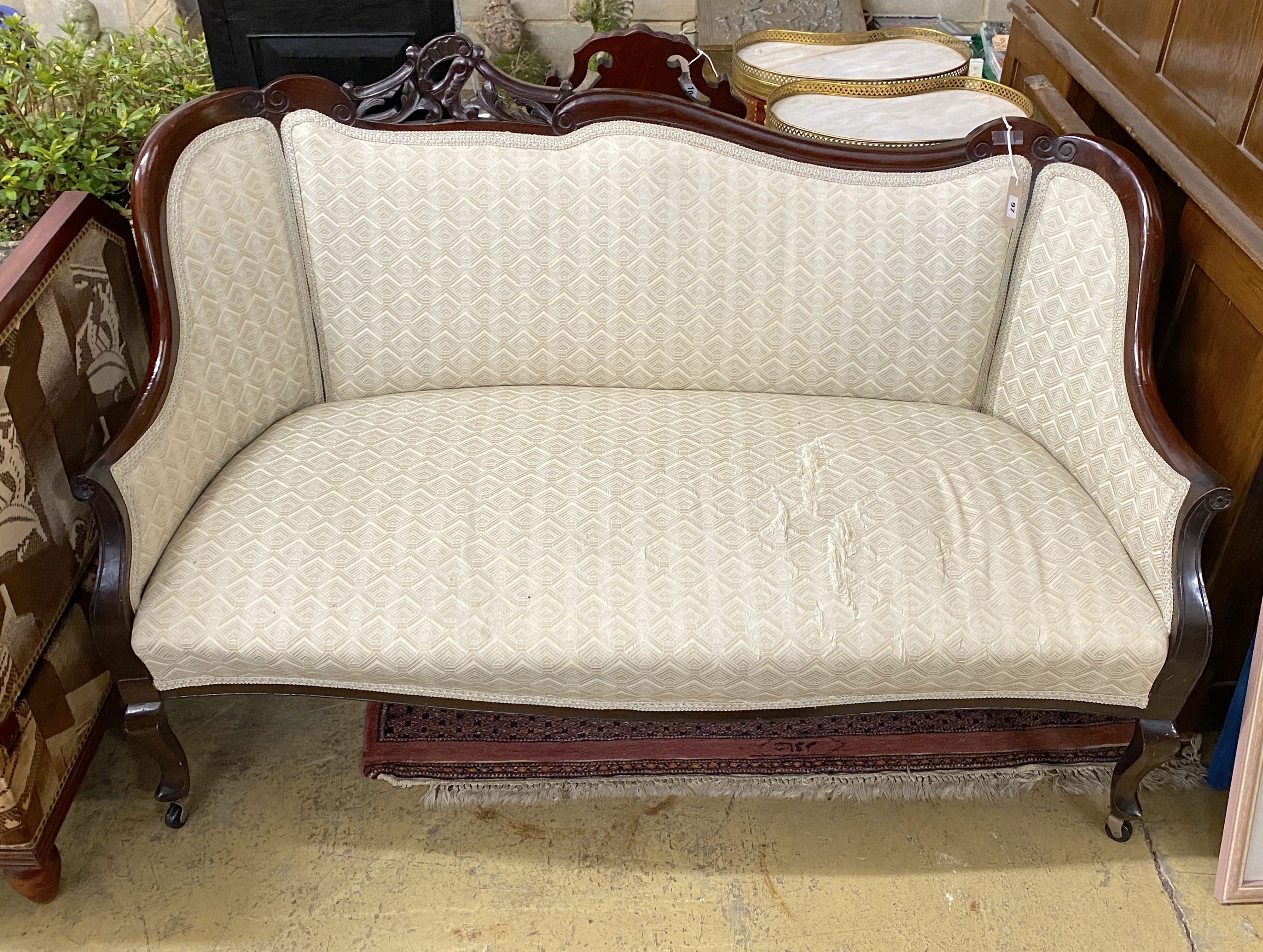 A late Victorian carved mahogany upholstered settee, length 140cm, depth 54cm, height 90cm